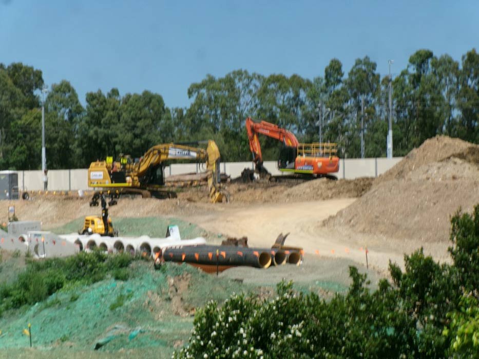 Large construction machinery adjacent to residential property, highlighting the need for a pre-construction dilapidation survey by RPEQ structural engineers in Brisbane